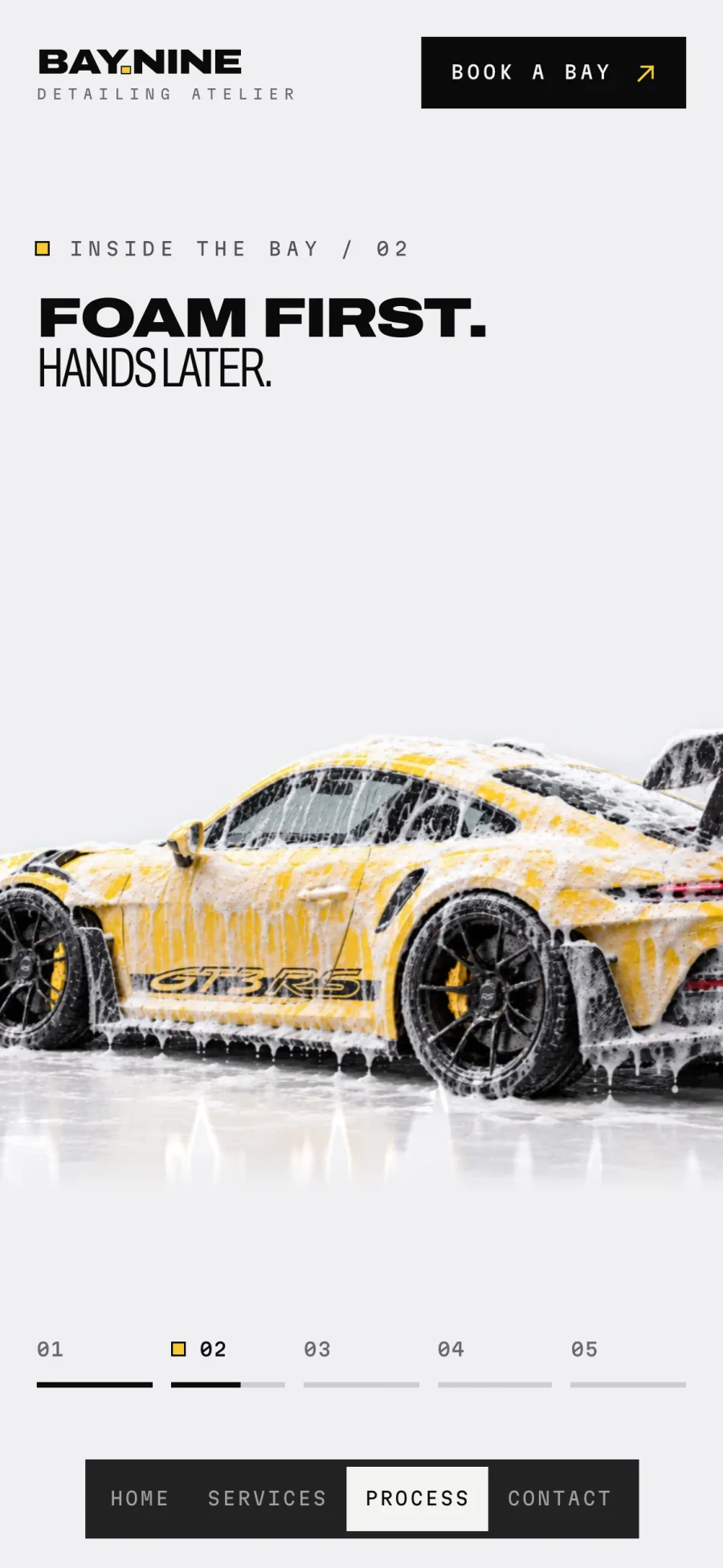 Inside the Bay on a phone, with snow foam covering the car